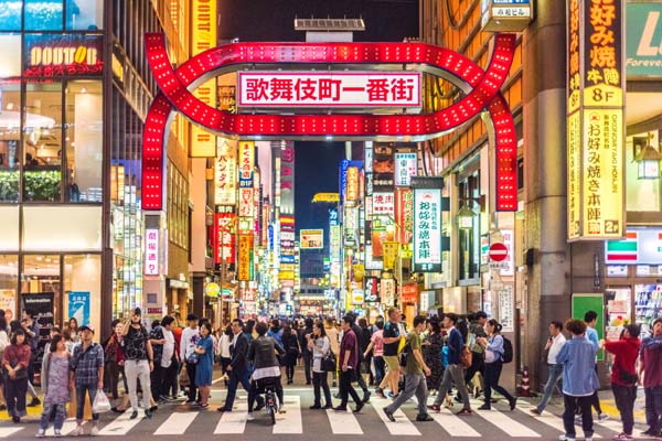 A crowded street with bright neon signs in Tokyo.