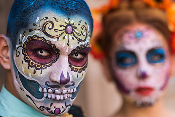 Skull design on a face made in honor of Día de los Muertos, a symbolic celebration of death in Mexican culture.