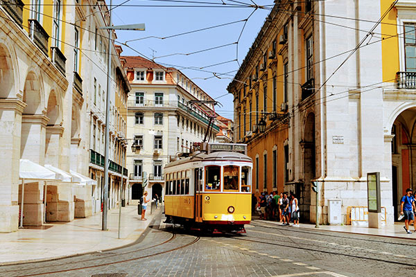 A trolley navigates through Lisbon, Portugal, a popular destination for American expats.